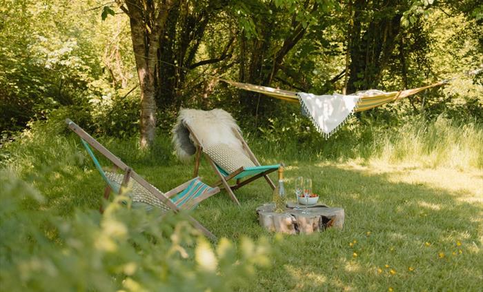 Relaxing by the river in the hammock and deckchairs - Luxury Glamping Cabin Carmarthenshire, West Wales